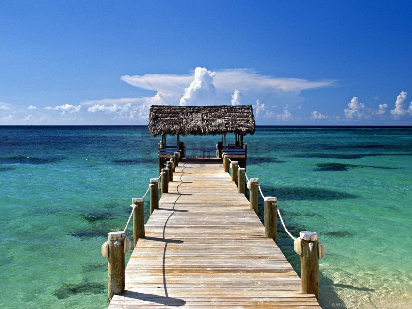 Wooden pier over clear turquoise Bahamian water