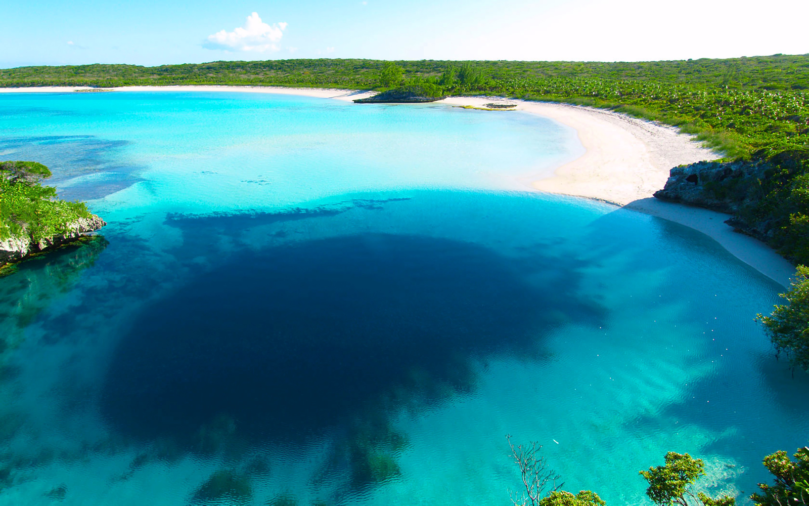 Turquoise Bahamian lagoon and white sand beach