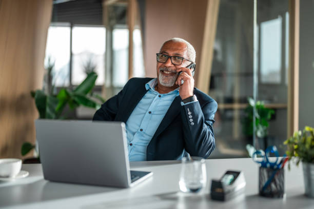 Business executive speaking on the phone in a modern office