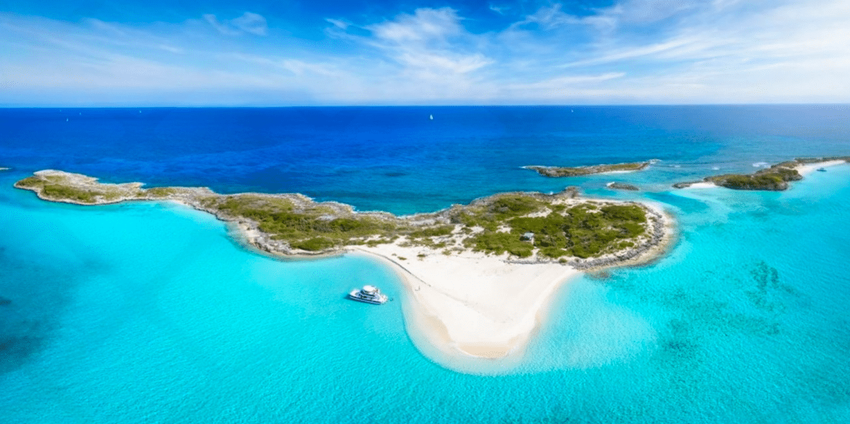 Aerial view of a small Bahamian island surrounded by turquoise water